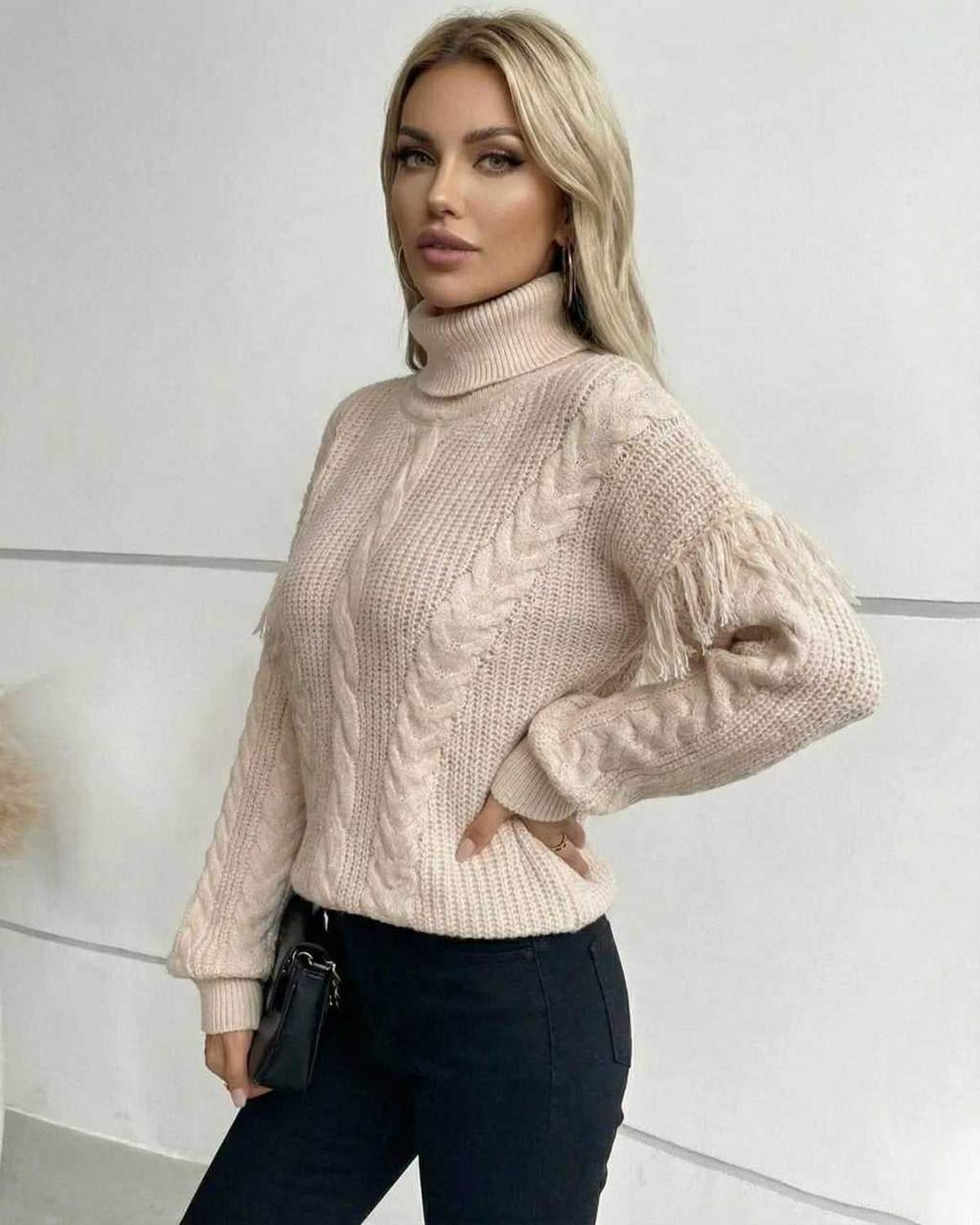 Vienna Sweater by Lauven – Women’s beige cable knit turtleneck with fringe detailing, perfect for fall winter style.