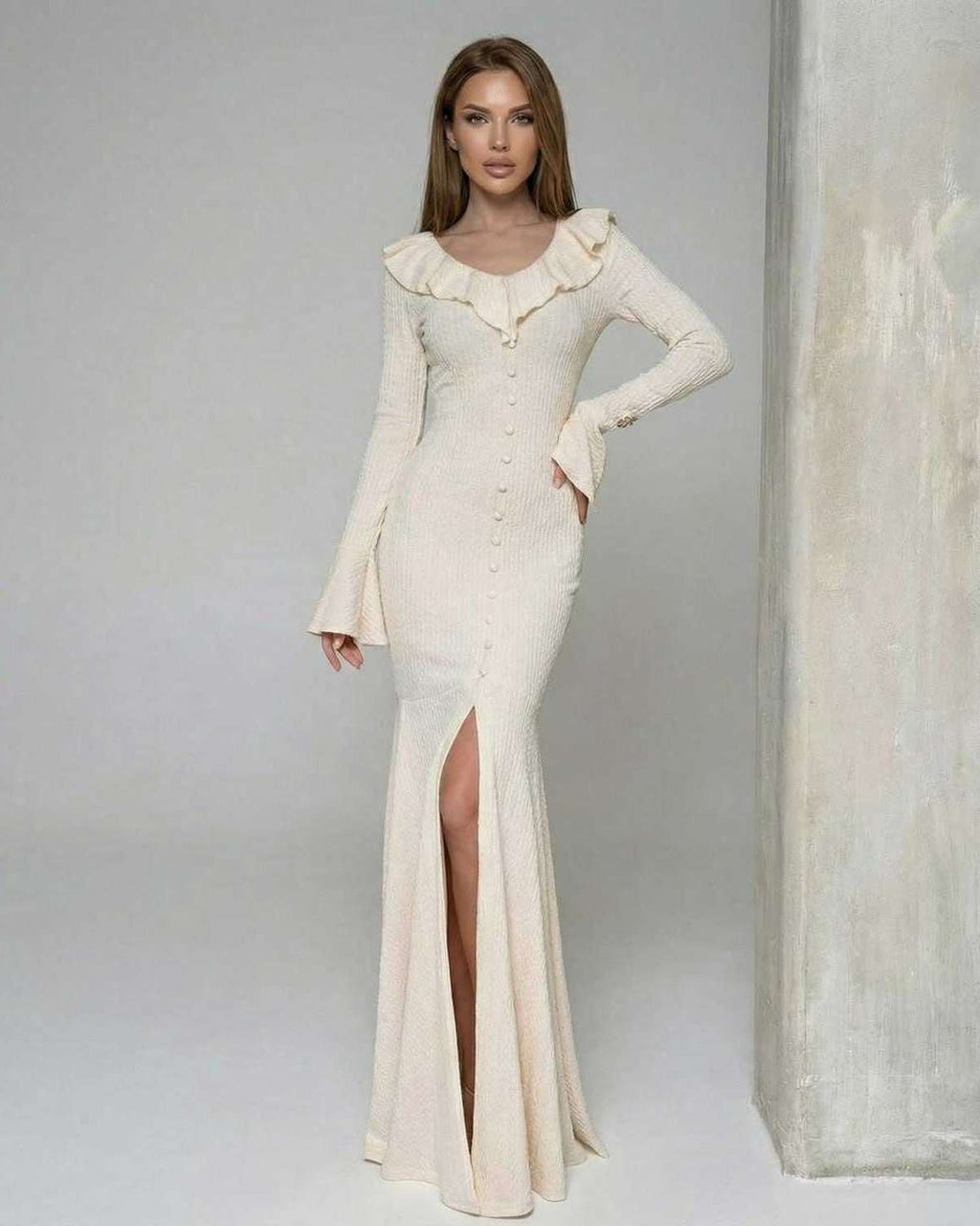 Sorrento Maxi Dress by Lauven - Women’s cream maxi dress with ruffle trim and long flare sleeves, featuring a high slit.