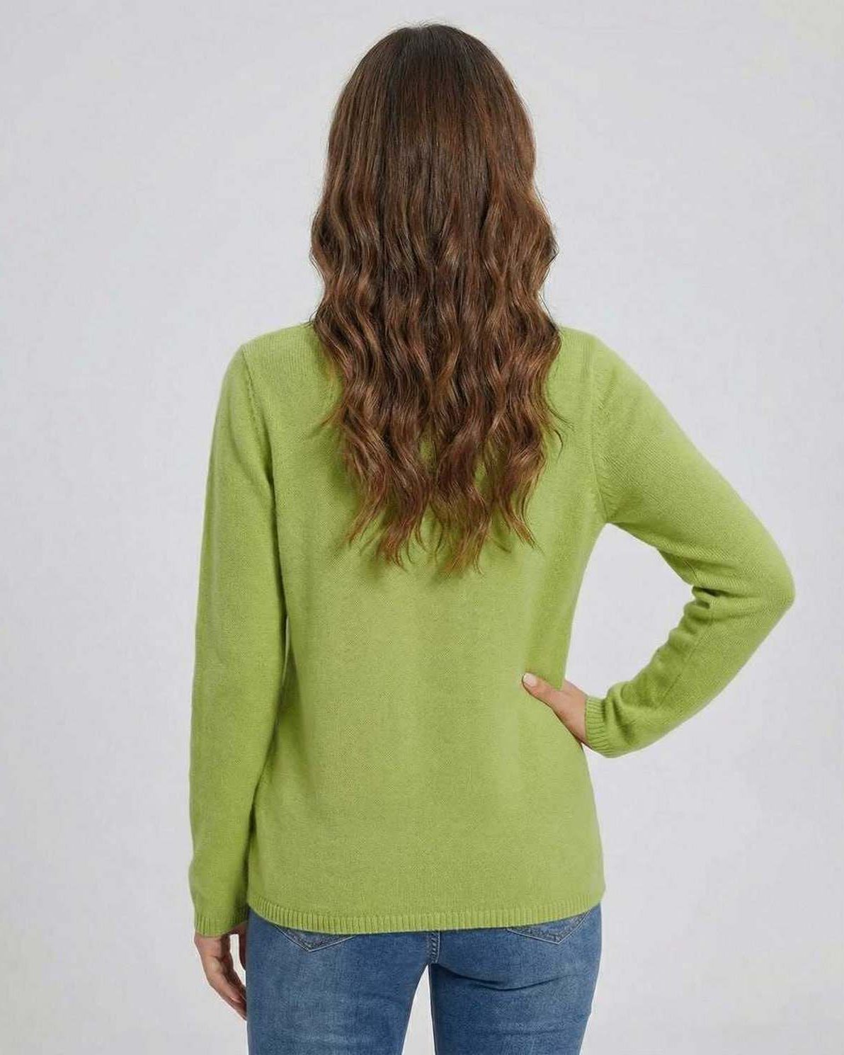 Back view of a woman wearing the Lauven Verona Sweater in green, featuring a comfortable fit and stylish design.
