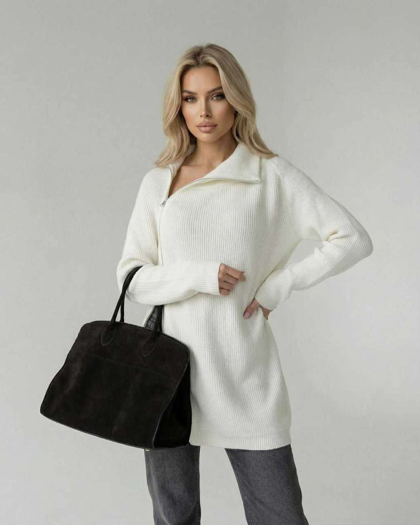 Women wearing Aspen Sweater by Lauven, a white turtleneck long sleeve sweater, stylishly holding a black bag.