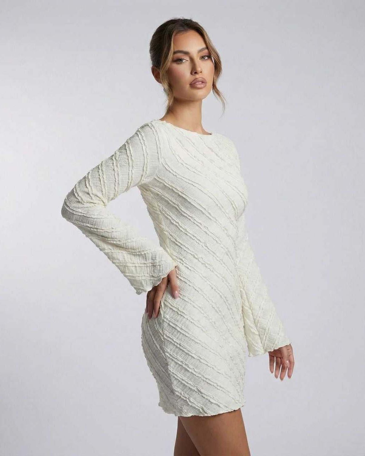 Sienna Mini Dress by Lauven – White textured long sleeve A-line dress showcasing elegant design and soft drape.