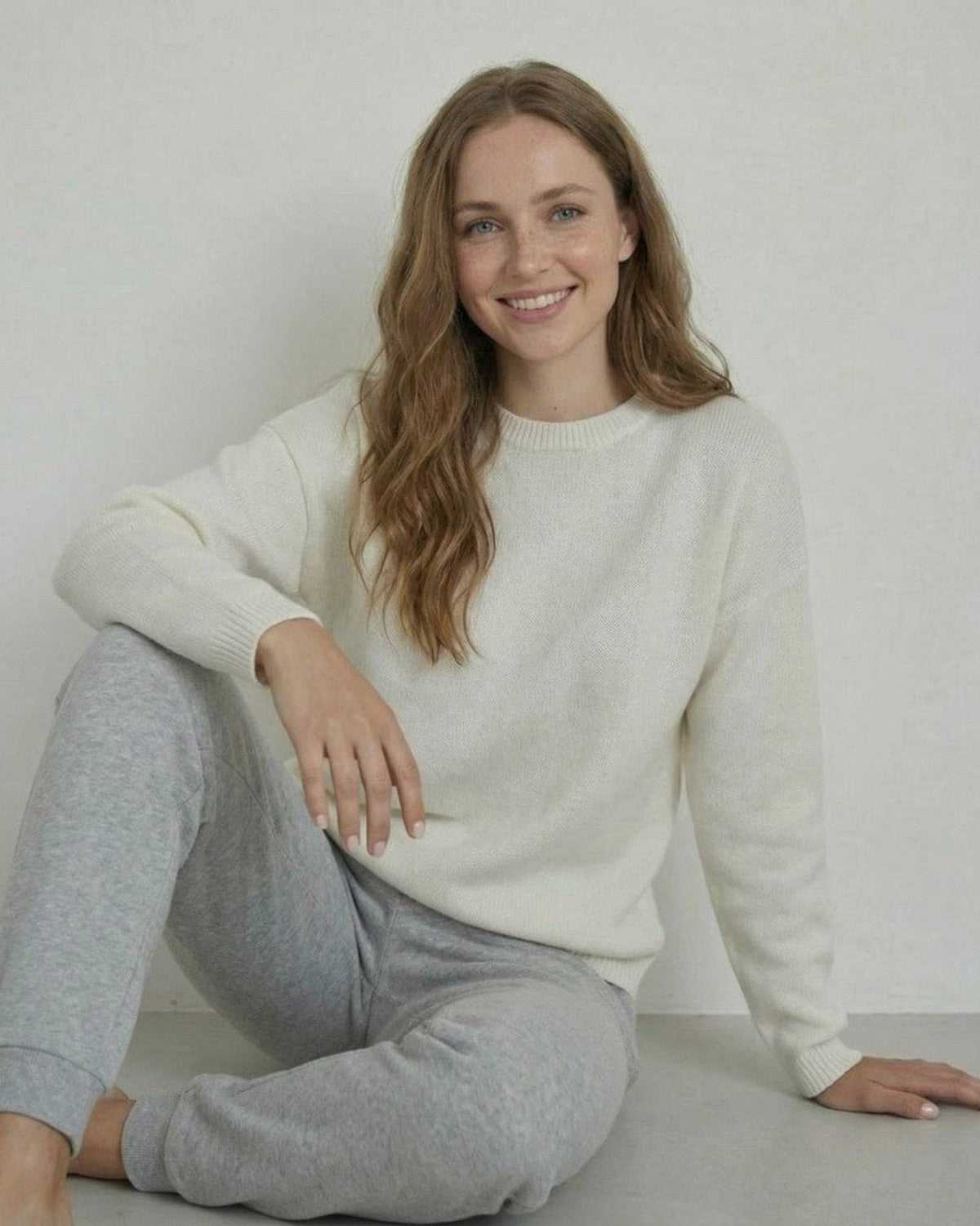 Alba Pullover by Lauven, relaxed wool knit pullover sweater in cream, styled casually with gray sweatpants.