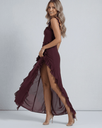 Amaranth Maxi Dress by Lauven in deep plum, featuring ruffled shoulders and thigh-high slit.