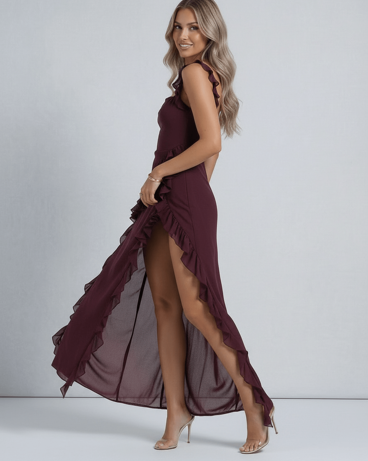 Amaranth Maxi Dress by Lauven in deep plum, featuring ruffled shoulders and thigh-high slit.