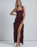 Amaranth Maxi Dress by Lauven in deep plum with ruffled shoulder straps and thigh-high side slit.