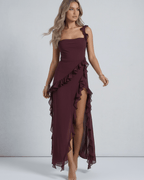 Amaranth Maxi Dress by Lauven, featuring deep plum sheer fabric, ruffled straps, and a thigh-high side slit.