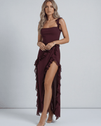 Lauven Amaranth Maxi Dress in deep plum with ruffled shoulder straps and thigh-high slit.