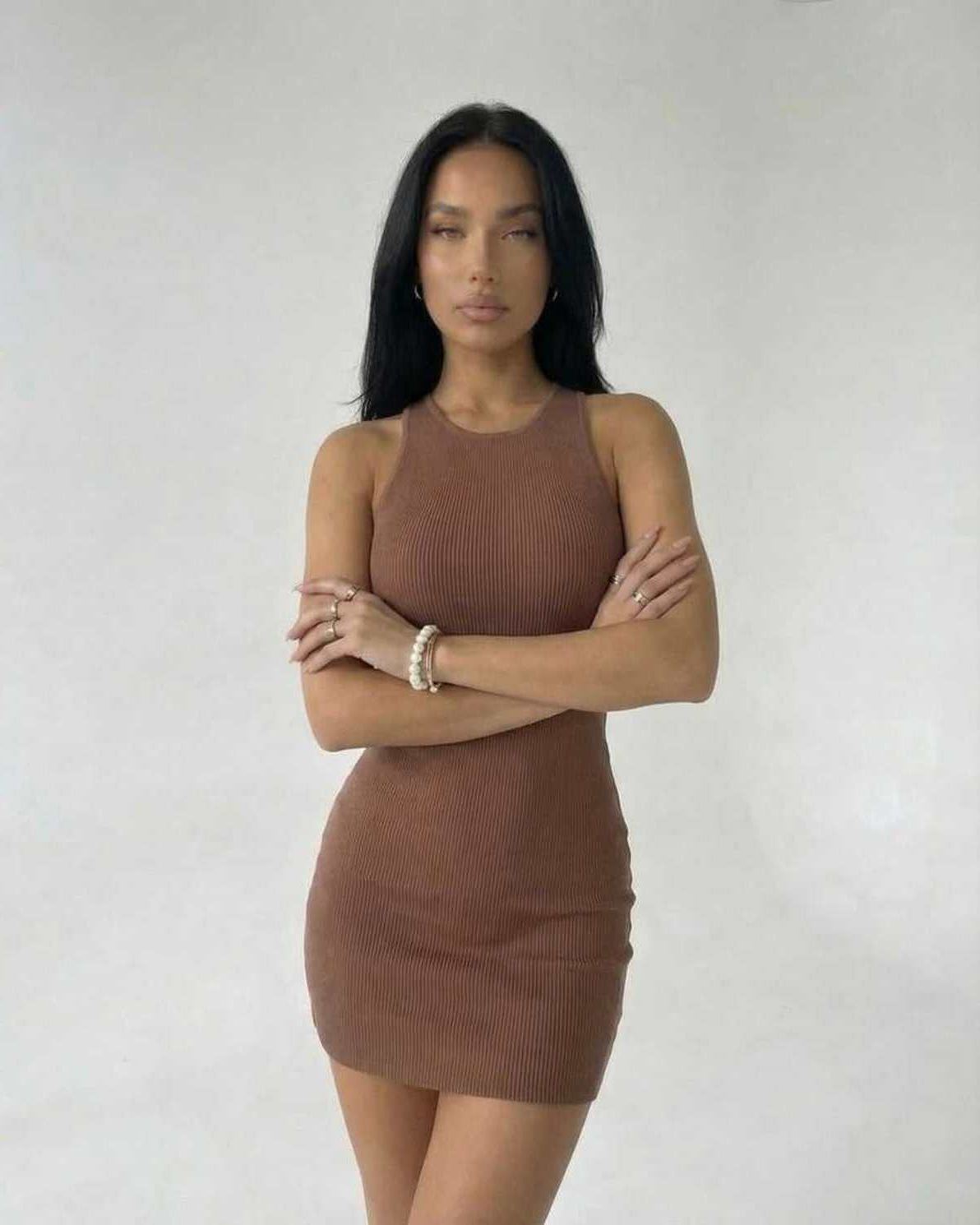 Arden Mini Dress in Brown Ribbed Knit by Lauven, showcasing a sleek sleeveless bodycon silhouette.