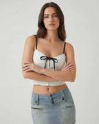 Arden Top by Lauven: White camisole with black bow detail, perfect for modern women's fashion.
