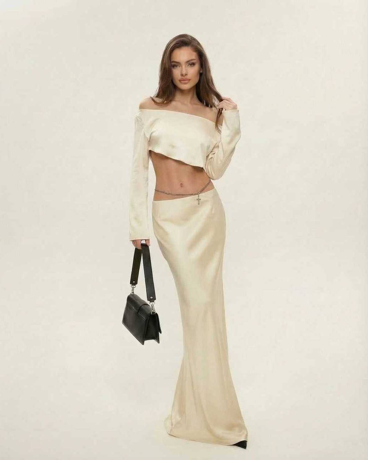 Model wearing the Aura Midi Dress by Lauven, featuring elegant satin finish in champagne, off-the-shoulder design.