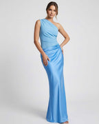 Model wearing Aurelia Maxi Dress, a blue one shoulder maxi dress featuring a sleek silhouette and elegant ruffles by Lauven.
