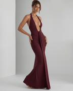 Aurelia Maxi Dress in burgundy with halter neck, featuring stretch jersey fabric, elegant ruching, and a modern silhouette.