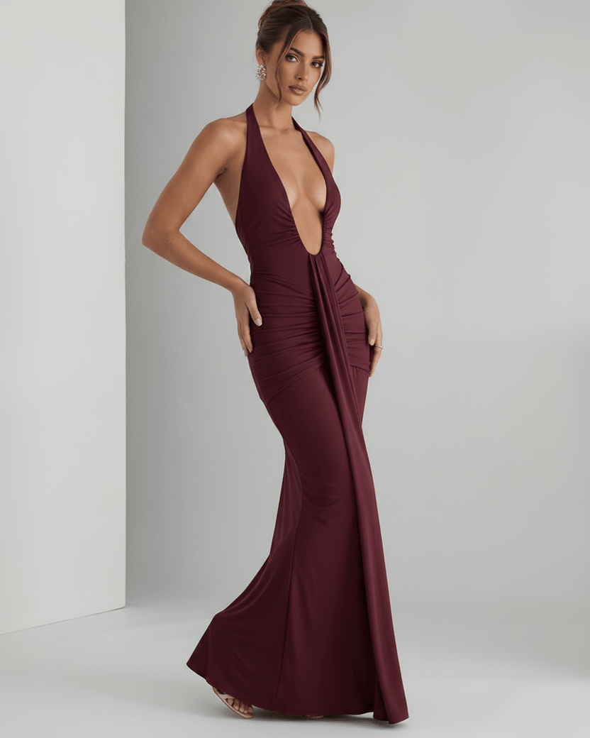 Aurelia Maxi Dress in burgundy with halter neck, featuring stretch jersey fabric, elegant ruching, and a modern silhouette.