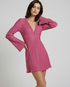 Aurora Mini Dress by Lauven in vibrant pink with pleated fabric and long flared sleeves.