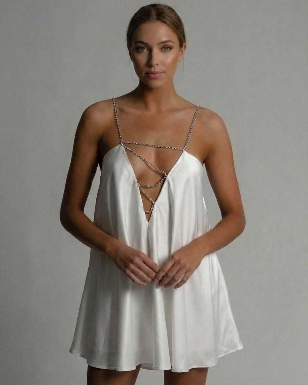 Aurora Mini Dress by Lauven featuring a satin A-line silhouette and hollow V-neckline with beaded straps.