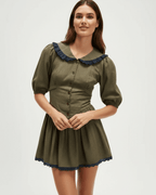 Aveline Mini Dress by Lauven featuring a Peter Pan collar, puff sleeves, and an olive green hue with navy accents.