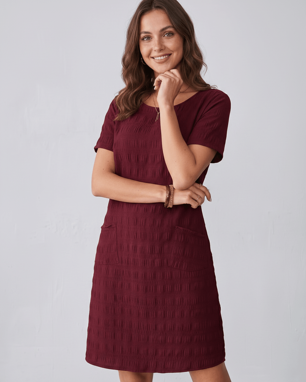 Avelin Mini Dress in burgundy, featuring textured fabric, round neckline, short sleeves, and a modern silhouette by Lauven.