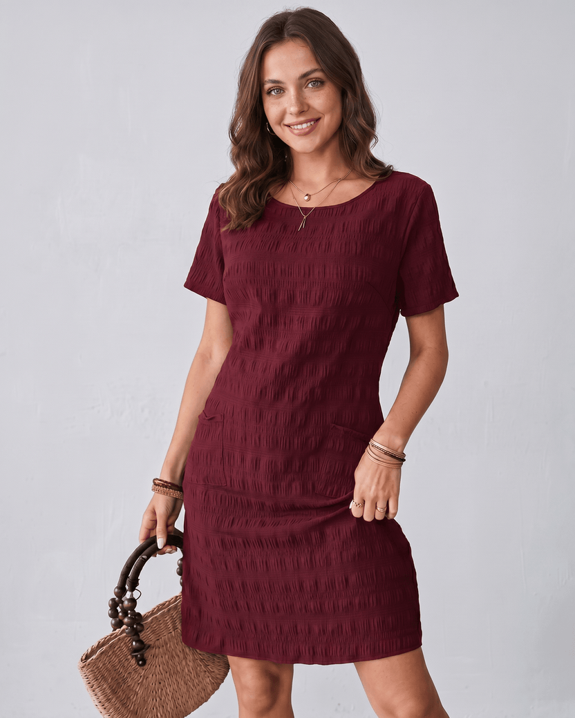 Avelin Mini Dress in textured fabric with round neckline by Lauven, offering a modern, versatile style for warm weather.