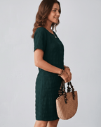 Avelin Mini Dress in textured fabric with round neckline, short sleeves, styled with a straw bag. Lauven brand.