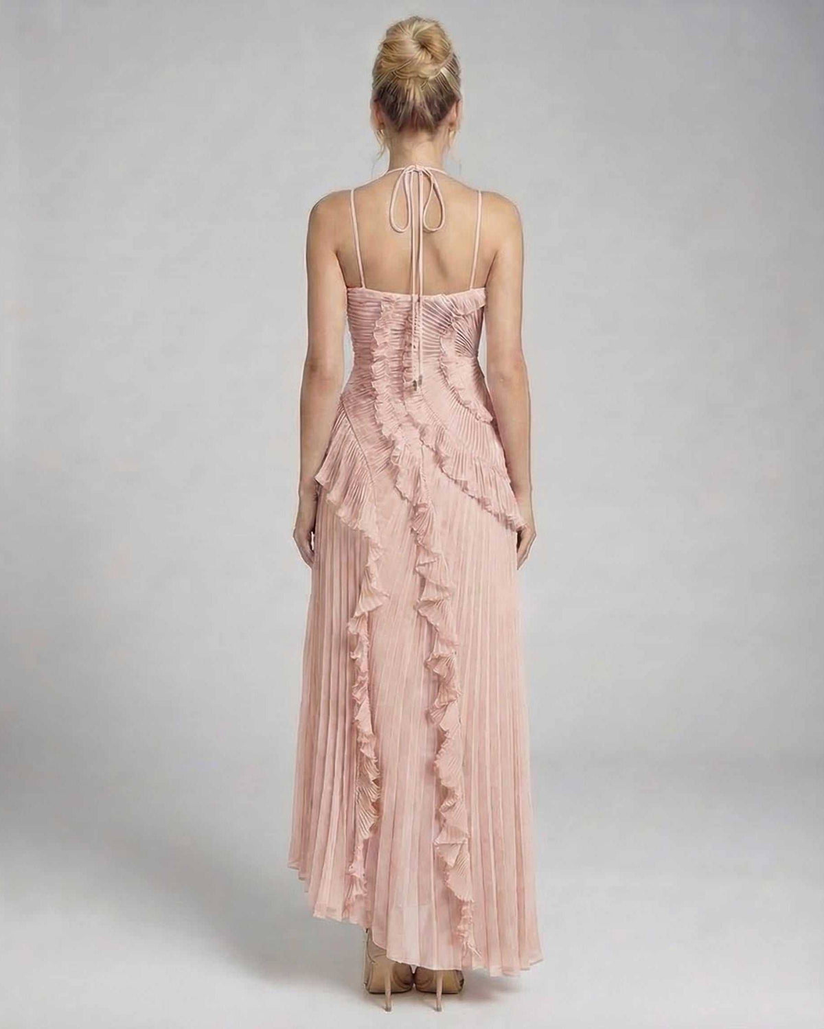 Back view of Blush Maxi Dress by Lauven, showcasing soft pink pleated chiffon and ruffle details.