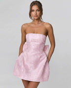 Blush Mini Dress by Lauven, strapless with elegant bow detail, showcasing a chic A-line silhouette.
