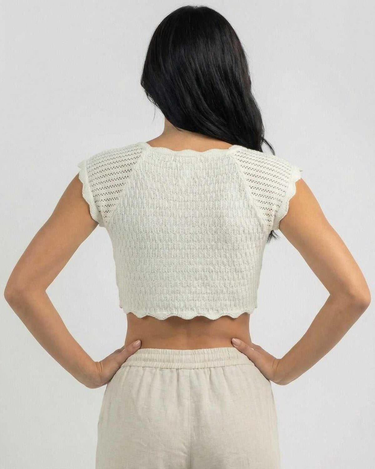 Back view of the Calista Top by Lauven, showcasing its unique lettuce trim design and comfortable fit.