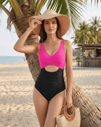 Calypso One-Piece Swimsuit in pink and black, featuring a cut-out design and ruching, perfect for beach style.