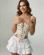 Model wearing Camellia Corset Top by Lauven, featuring floral lace-up design and structured silhouette.