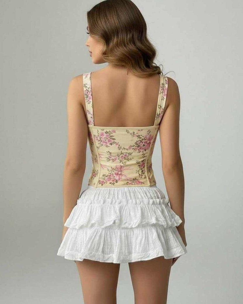Back view of a woman wearing the Camellia Corset Top by Lauven, featuring floral design and structured silhouette.