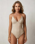 Lauven Capri One-Piece Swimsuit in beige, features ribbed texture and lace-up neckline for stylish beachwear.