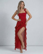 Lauven Carmine Maxi Dress in sheer red with ruffled shoulder straps and asymmetric hemline.
