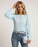 Celeste Blouse by Lauven in light blue with pleated design, elegant long sleeves, and styled with denim.
