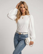 Celeste Blouse by Lauven, elegant white pleated long sleeve top styled with jeans and a clutch.