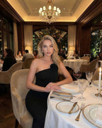 Celeste Maxi Dress worn by a model in a stylish restaurant setting, showcasing elegance and sophistication.