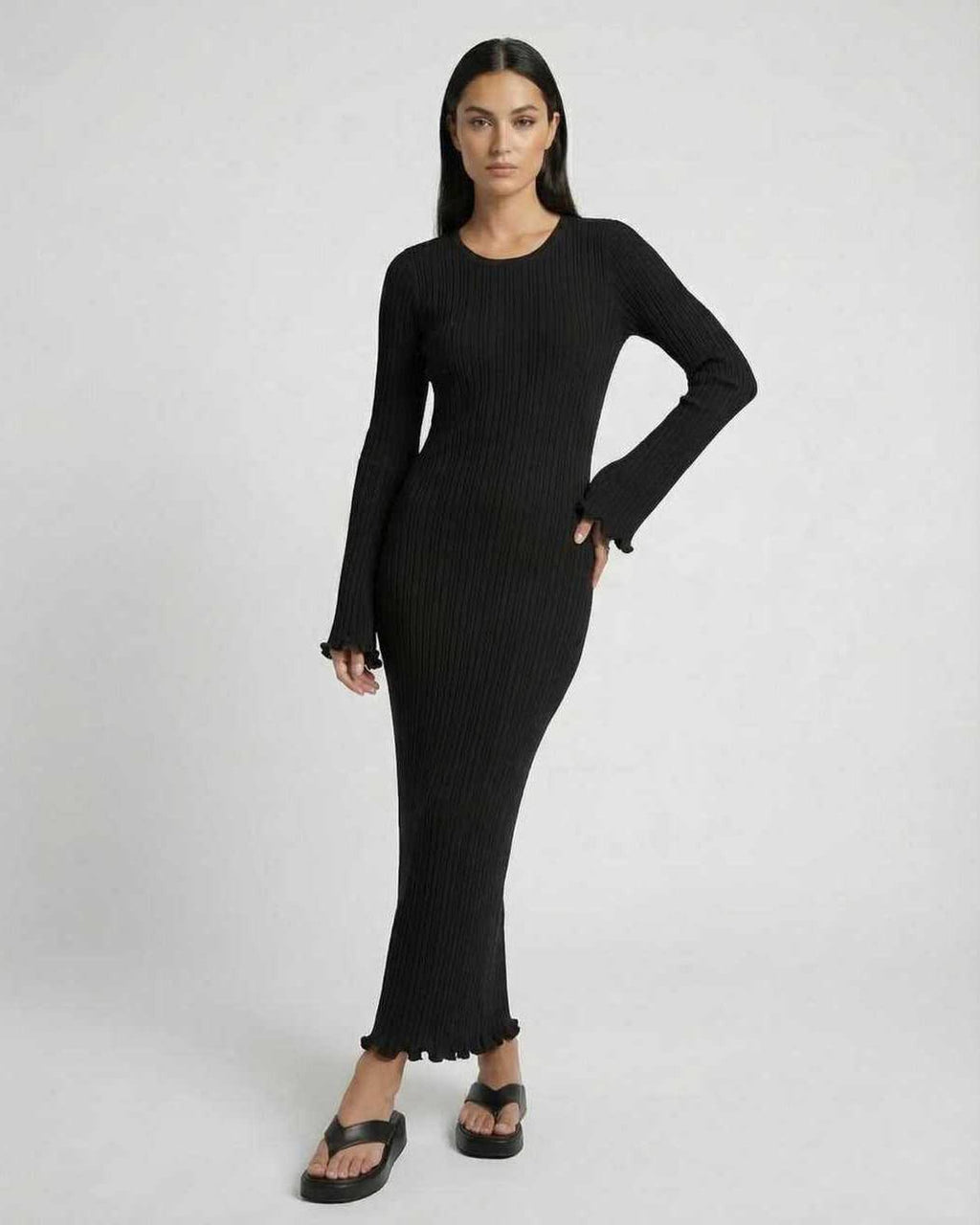 Lauven Celeste Maxi Dress in black, elegant ribbed knit with long flared sleeves and ruffle details.