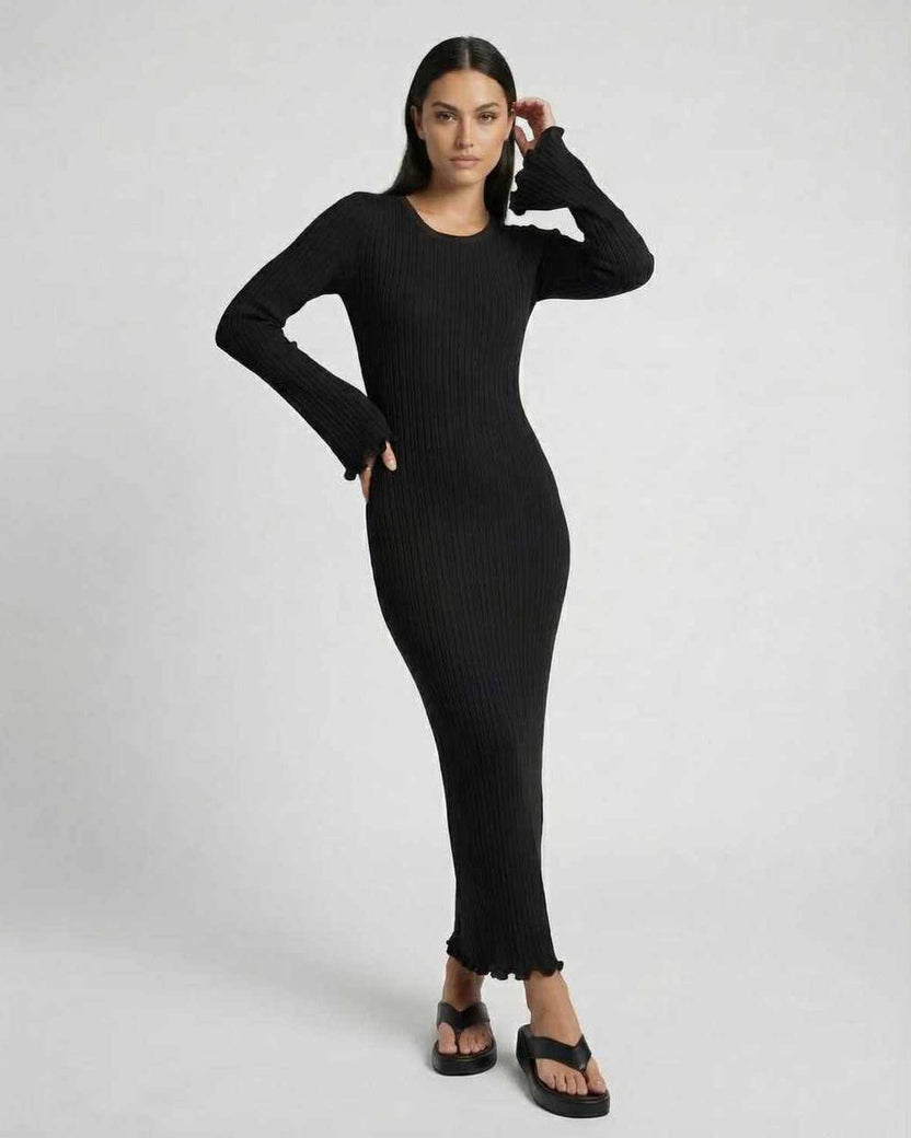 Lauven Celeste Maxi Dress in black ribbed knit with ruffle details and long flared sleeves.