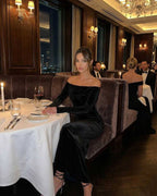 Celeste Maxi Dress worn in an elegant restaurant, showcasing its off-shoulder design, sleek silhouette, by Lauven.