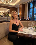 Celeste Maxi Dress by Lauven worn by a woman at an elegant restaurant, showcasing a chic, textured design.