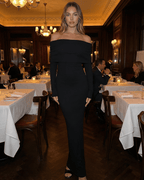 Celeste Maxi Dress by Lauven, off-shoulder long sleeve black formal dress in an elegant restaurant setting.