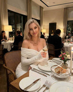 Celeste Maxi Dress by Lauven - Elegant off-shoulder design at a stylish dinner setting.