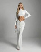 Celeste Maxi Dress by Lauven showcases sleek white ankle-length elegance with a fitted silhouette and subtle ruching.