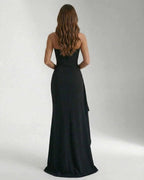 Back view of the Celeste Maxi Dress by Lauven, featuring a sleek and elegant strapless design and thigh-high slit.