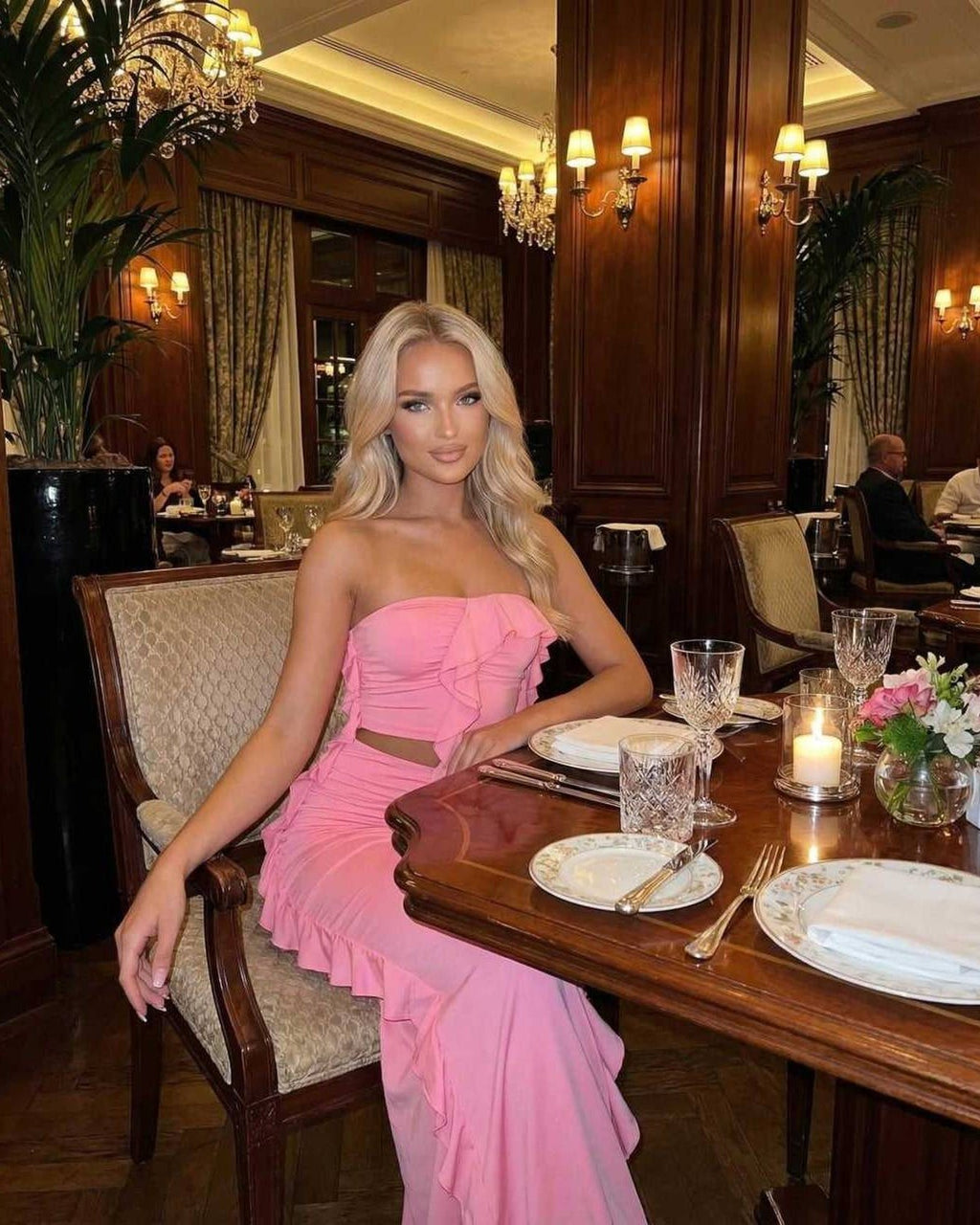 Celeste Maxi Dress by Lauven, elegant pink ruffle accent dress worn at a fine dining setting.