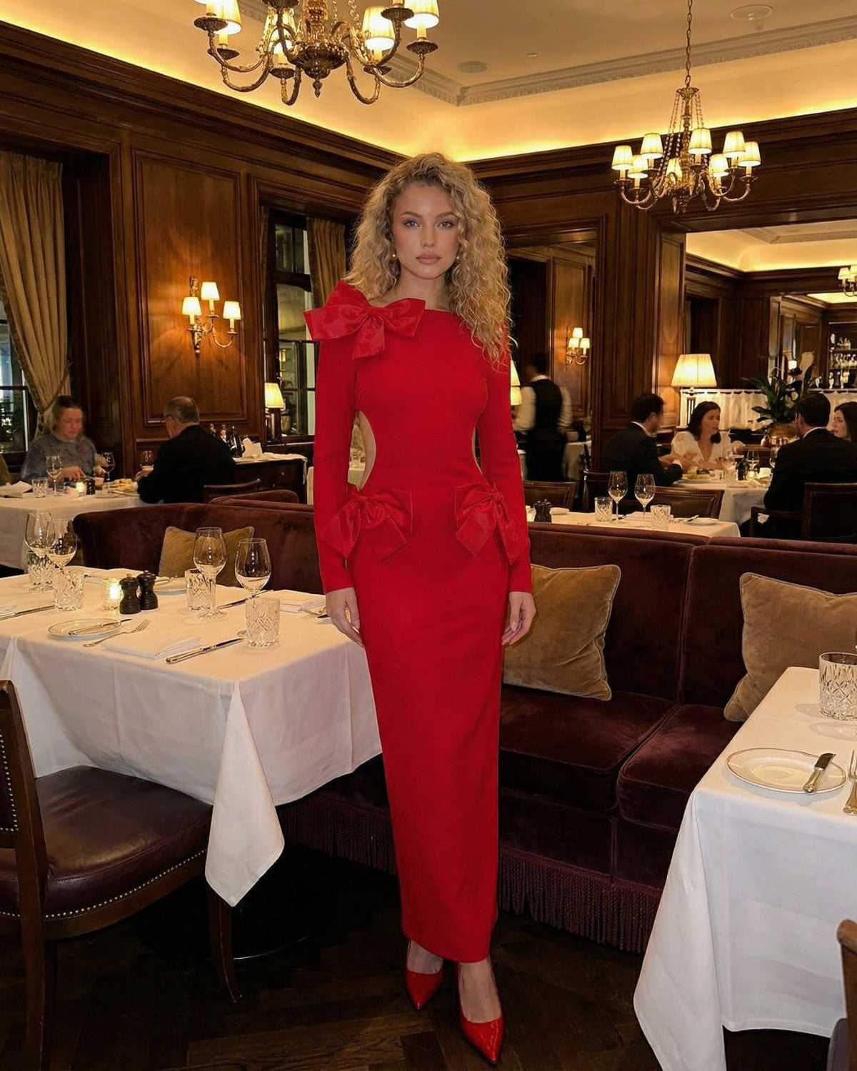 Celeste Maxi Dress by Lauven in elegant red with bow accents, showcasing a slim fit sheath silhouette in a dining setting.