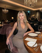 Model wearing the Celeste Maxi Dress by Lauven in a chic restaurant setting.