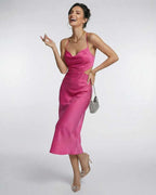 Celeste Midi Dress by Lauven in vibrant pink satin with elegant cutout design and criss-cross back, perfect for events.