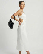Celeste Midi Dress by Lauven showcasing a ruched sleeveless design and backless strappy detail in white.