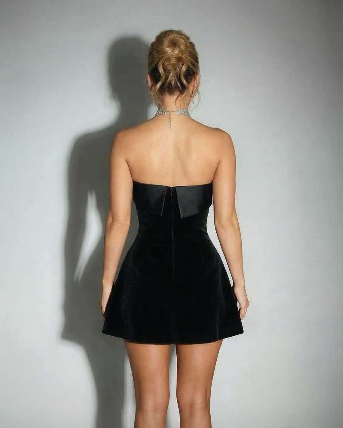 Celeste Mini Dress back view showcases elegant strapless design in black velvet, perfect for a sophisticated look by Lauven.