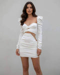 Celeste Mini Dress by Lauven, elegant white satin design with chain detail and flattering ruched skirt.