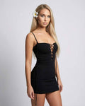 Celeste Mini Dress by Lauven, a sleek black sheath with spaghetti straps and lace-up detail, showcasing modern luxury.